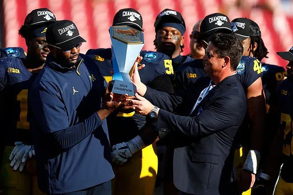 Sherrone Moore, Michigan Team, and ReliaQuest Bowl Trophy