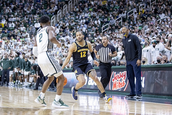 DeVante' Jones (12) and Juwan Howard
