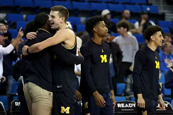 Will Tschetter (42) and Michigan Team