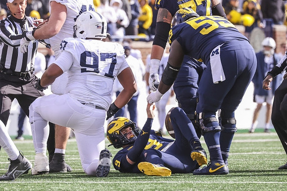J.J. McCarthy (9) and Olusegun Oluwatimi (55)