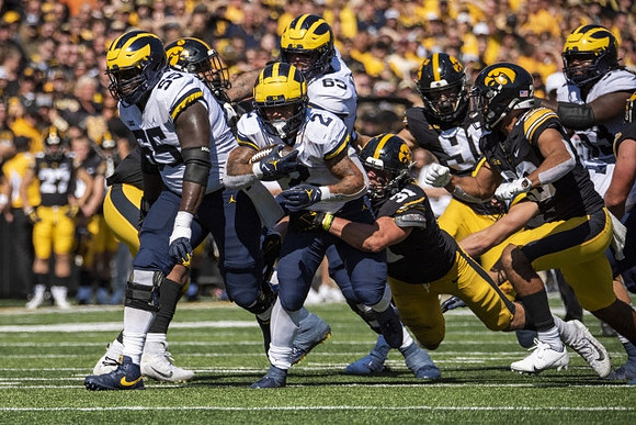 Olusegun Oluwatimi (55), Blake Corum (2), and Zak Zinter (65)