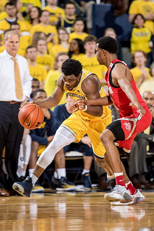 Derrick Walton Jr. (10) and John Beilein
