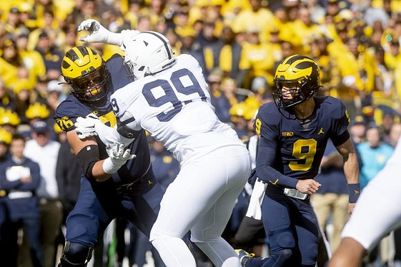 Ryan Hayes (76) and J.J. McCarthy (9)