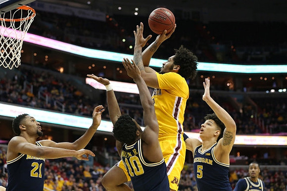 Zak Irvin (21), Derrick Walton Jr. (10), D.J. Wilson (5), and Muhammad-Ali Abdur-Rahkman (12)
