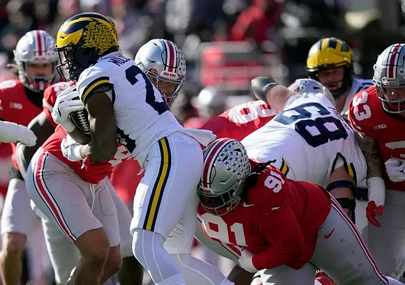 Kalel Mullings (20) and Josh Priebe (68)