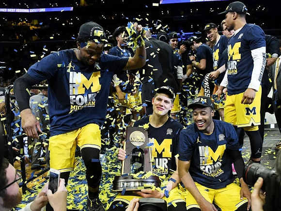 Zavier Simpson (3), Moritz Wagner (13), Muhammad-Ali Abdur-Rahkman (12), Michigan Team, and West Regional Championship Trophy