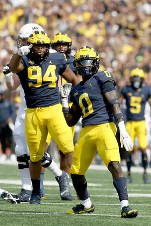 Kris Jenkins (94) and Mike Sainristil (0)