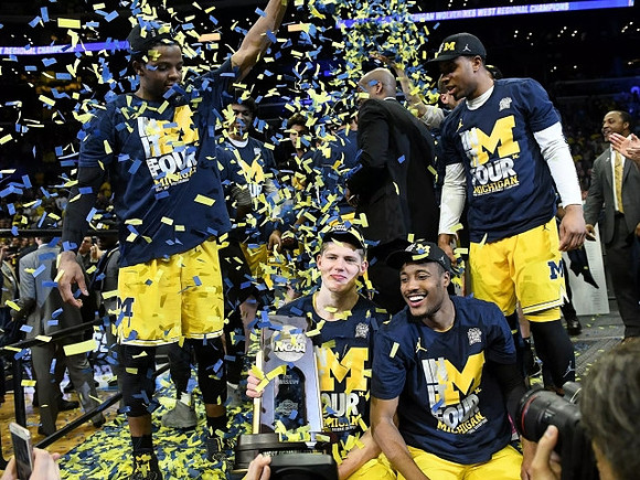 Zavier Simpson (3), Moritz Wagner (13), Muhammad-Ali Abdur-Rahkman (12), Jaaron Simmons (5), and West Regional Championship Trophy