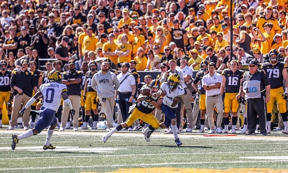 Mike Sainristil (0) and DJ Turner (5)
