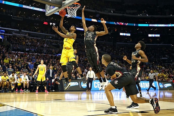 Charles Matthews (1), Duncan Robinson (22), and John Beilein