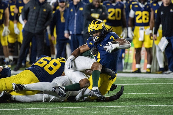 Josh Priebe (68) and Donovan Edwards (7)