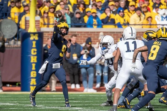 J.J. McCarthy (9) and Ronnie Bell (8)