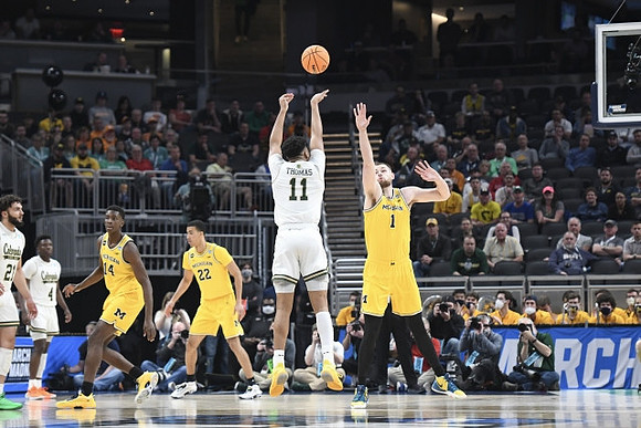 Hunter Dickinson (1), Moussa Diabate (14), and Caleb Houstan (22)