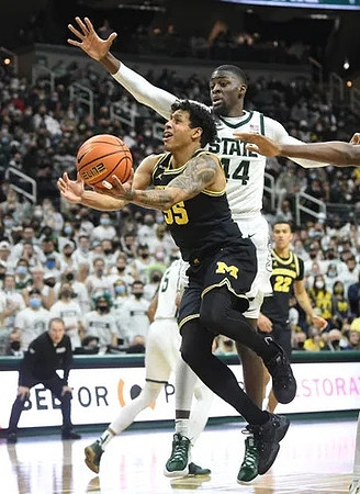 Michigan State Head Coach Tom Izzo, Eli Brooks (55), and Caleb Houstan (22)