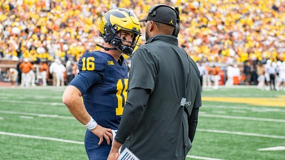 Davis Warren (16) and Sherrone Moore