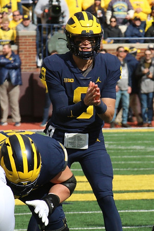 Zak Zinter (65) and J.J. McCarthy (9)