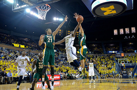 Kameron Chatman (3), Derrick Walton Jr. (10), and Caris LeVert (23)