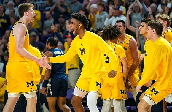 Danny Wolf (1) and Michigan Team