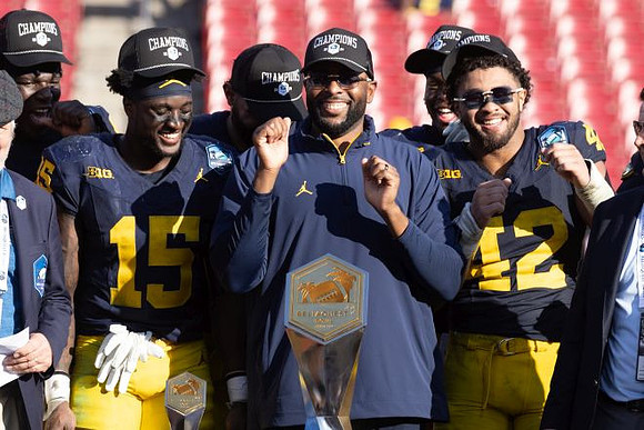 Sherrone Moore, Michigan Team, and ReliaQuest Bowl Trophy
