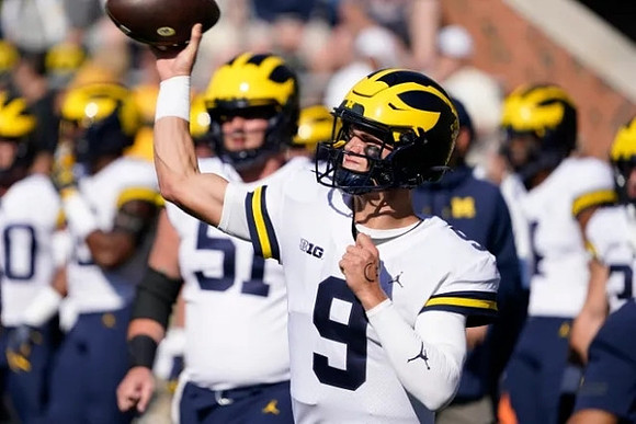 J.J. McCarthy (9) and Greg Crippen (51)