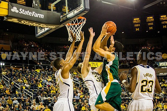 Zak Irvin (21), Mark Donnal (34), and Caris LeVert (23)