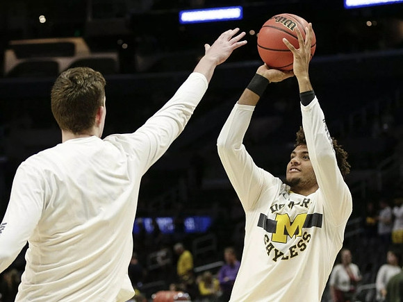 Jon Teske (15) and Isaiah Livers (4)