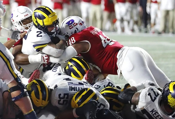 Blake Corum (2), Giovanni El-Hadi (58), Olusegun Oluwatimi (55), Colston Loveland (18), and Trevor Keegan (77)