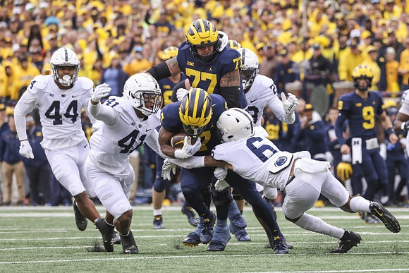 Donovan Edwards (7), Trevor Keegan (77), and J.J. McCarthy (9)
