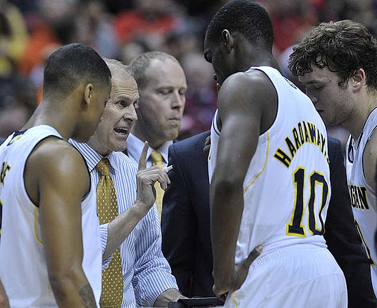 Trey Burke (3), John Beilein, Tim Hardaway Jr. (10), and Zack Novak (0)