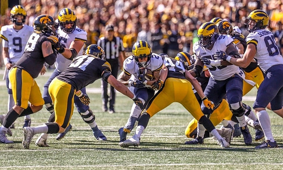 J.J. McCarthy (9), Zak Zinter (65), Blake Corum (2), Olusegun Oluwatimi (55), and Luke Schoonmaker (86)