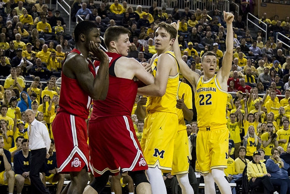 Mark Donnal (34), Duncan Robinson (22), and John Beilein