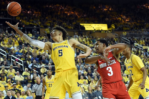 D.J. Wilson (5), Zak Irvin (21), and Muhammad-Ali Abdur-Rahkman (12)