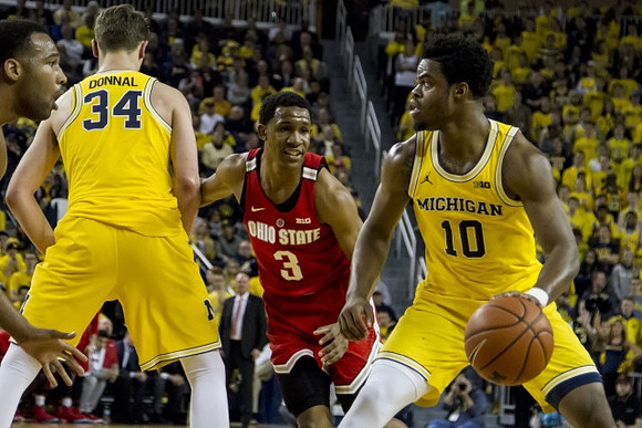 Mark Donnal (34) and Derrick Walton Jr. (10)