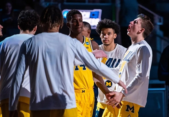 Moussa Diabate (14) and Michigan Team