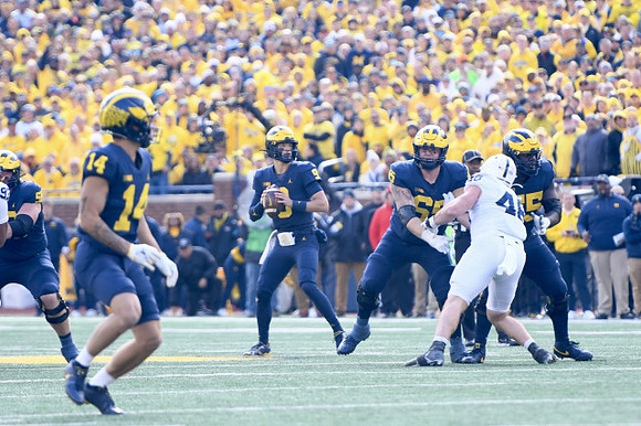Roman Wilson (14), J.J. McCarthy (9), Zak Zinter (65), and Olusegun Oluwatimi (55)