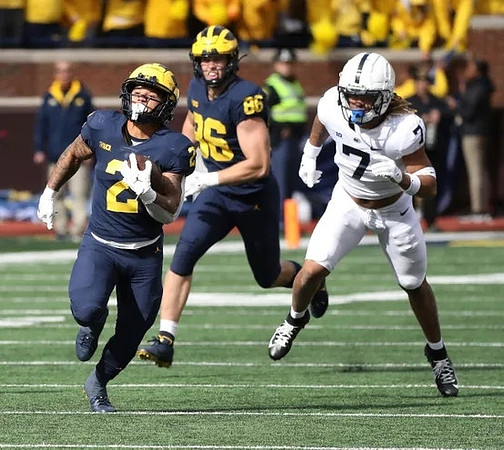 Blake Corum (2) and Luke Schoonmaker (86)
