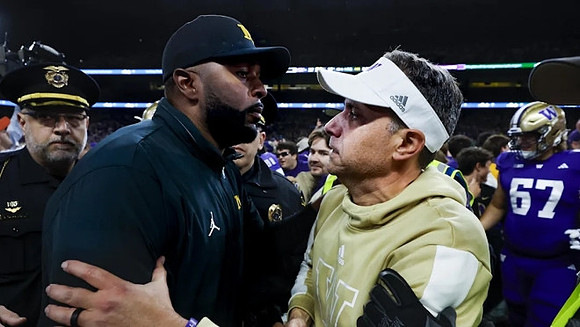 Sherrone Moore and Washington Head Coach Jedd Fisch