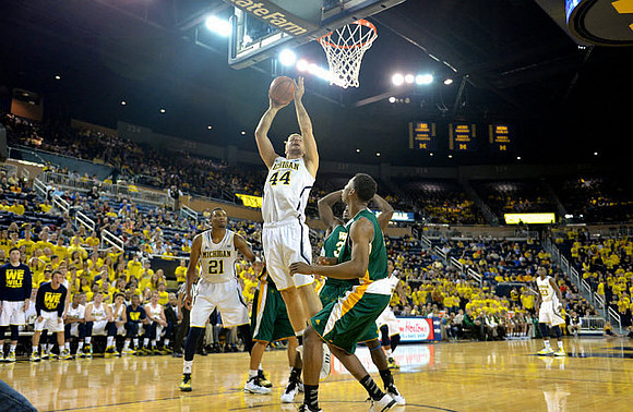 Zak Irvin (21), Max Bielfeldt (44), and Caris LeVert (23)