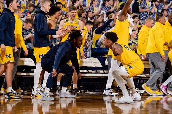 Gregg Glenn III (23), Jace Howard (25), and Michigan Team