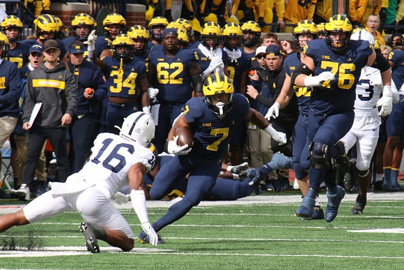 Donovan Edwards (7) and Ryan Hayes (76)