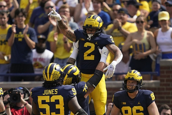 Trente Jones (53), Trevor Keegan (77), Blake Corum (2), and Luke Schoonmaker (86)