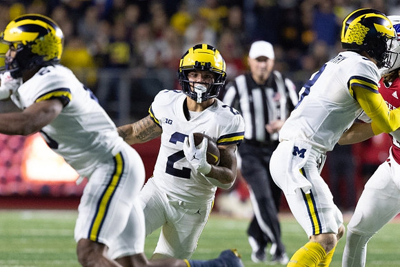 Cornelius Johnson (6), Blake Corum (2), and J.J. McCarthy (9)