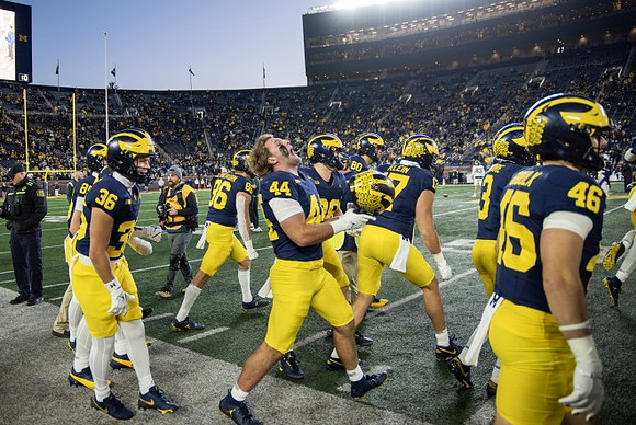 Max Bredeson (44) and Michigan Team