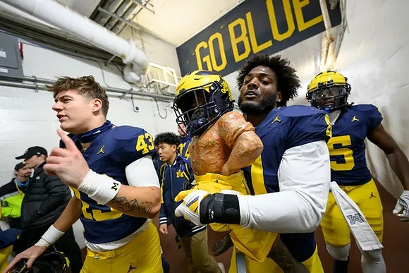 Deakon Tonielli (43) and Paul Bunyan Trophy