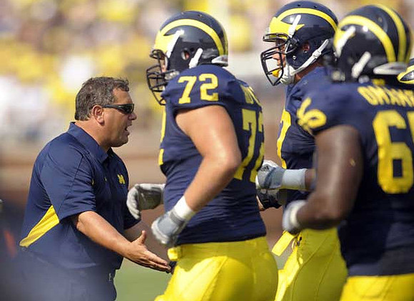 Brady Hoke, Mark Huyge (72), Taylor Lewan (77), and Patrick Omameh (65)