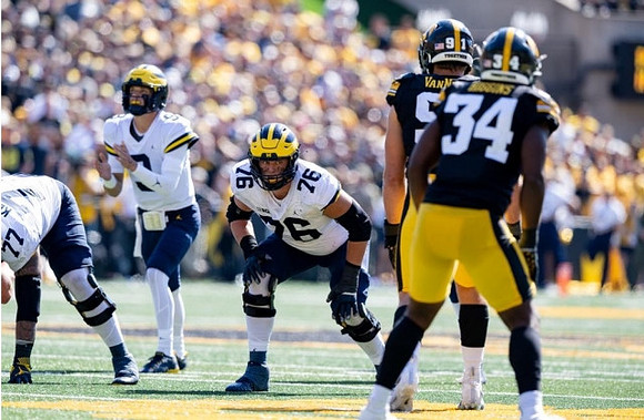 Trevor Keegan (77), J.J. McCarthy (9), and Ryan Hayes (76)