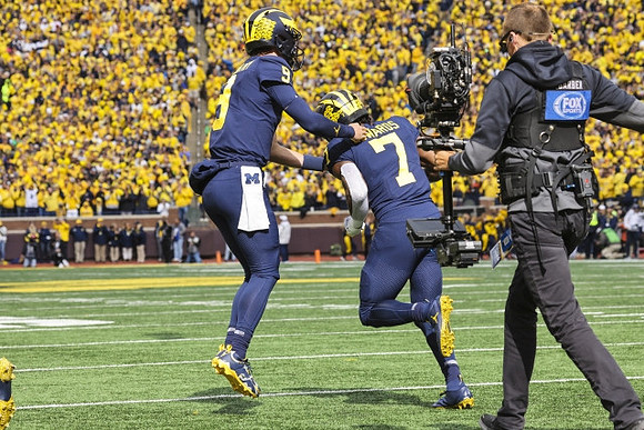J.J. McCarthy (9) and Donovan Edwards (7)