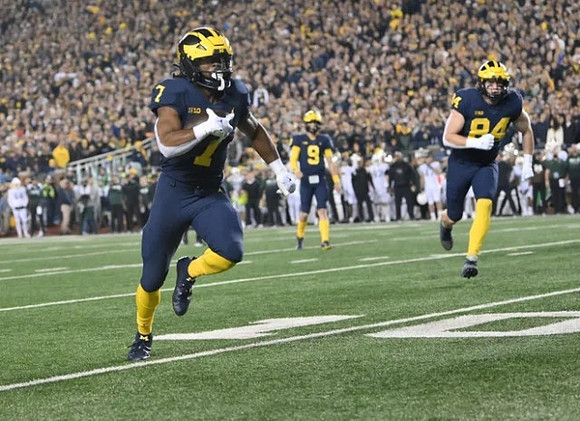 Donovan Edwards (7), J.J. McCarthy (9), and Joel Honigford (84)