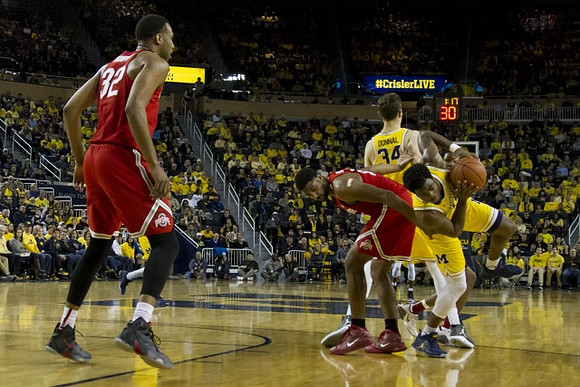 Mark Donnal (34) and Derrick Walton Jr. (10)