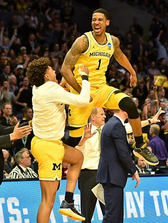 Jordan Poole (2), Charles Matthews (1), John Beilein, and Luke Yaklich